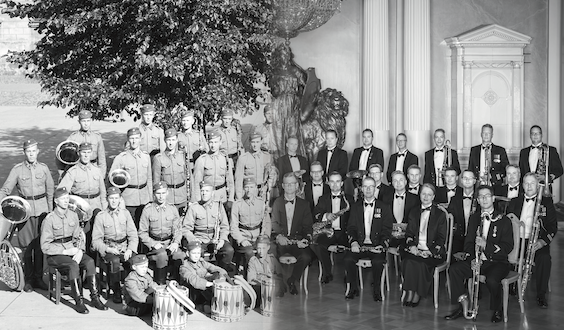 To the left is an old group photo of musicians. On the right is a newer group photo of musicians.